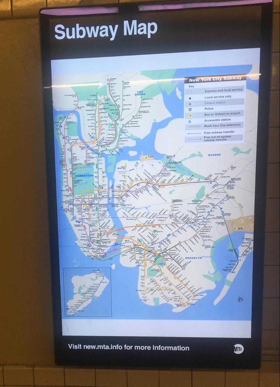 A photograph of a TV in a subway station with the “paper” map displayed.